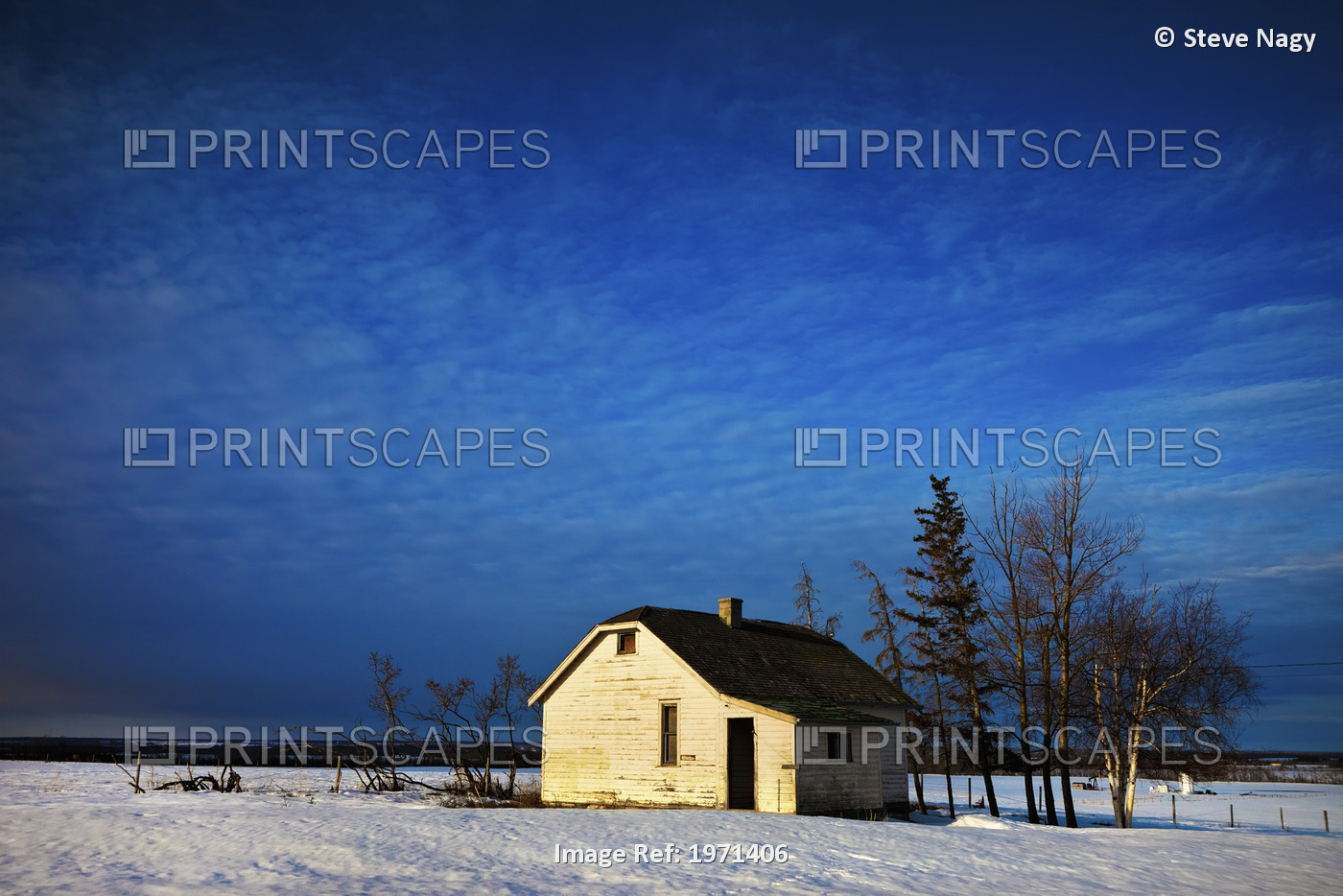An Abandoned Homestead On A Snow Covered Field; Alberta, Canada