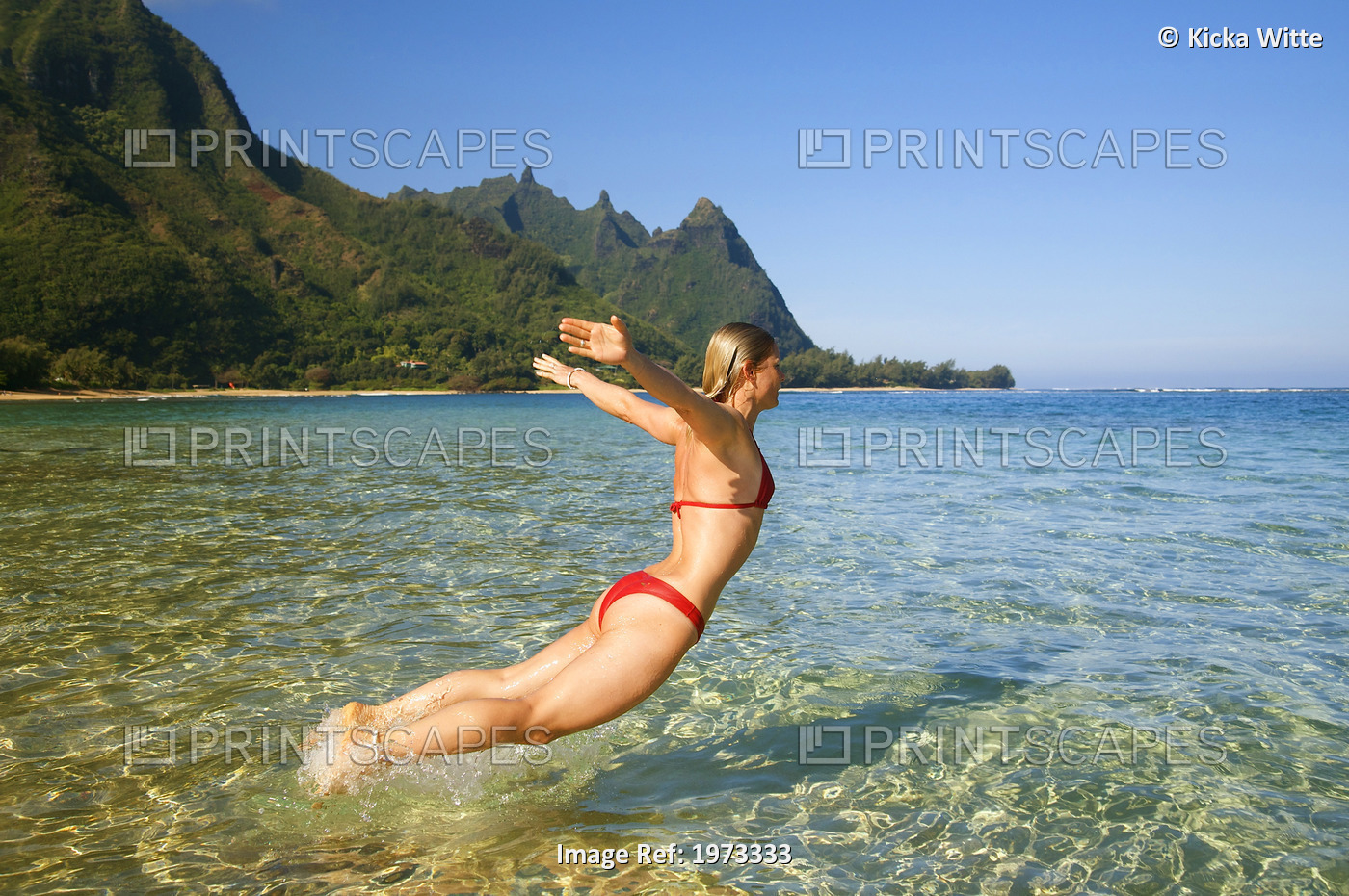 Hawaii, Kauai, Tunnel's Beach, Woman Leaps Into The Ocean.