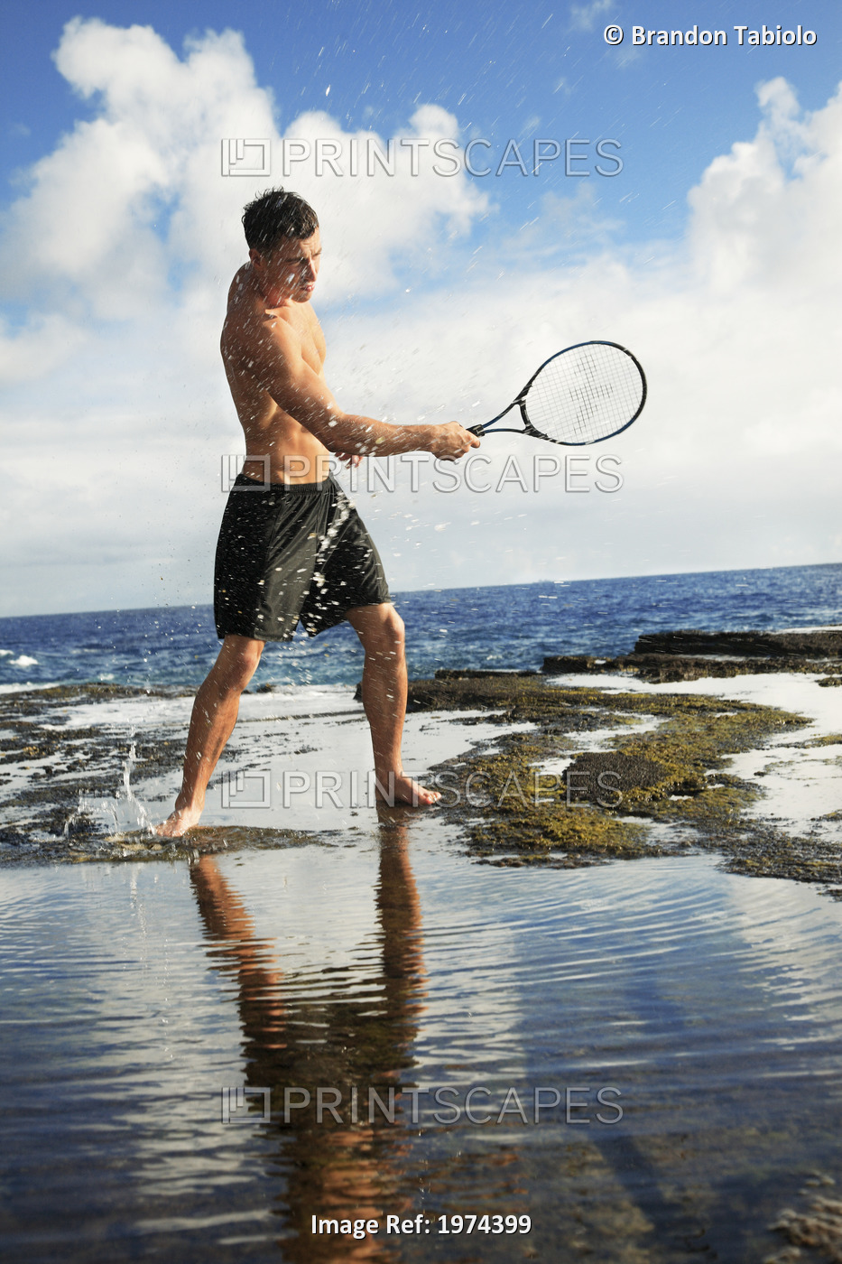 Hawaii, Oahu, Fit Male Swinging A Tennis Racket At The Tidepool.