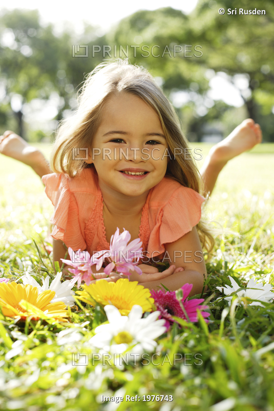 Girl Playing With Flowers In Grass