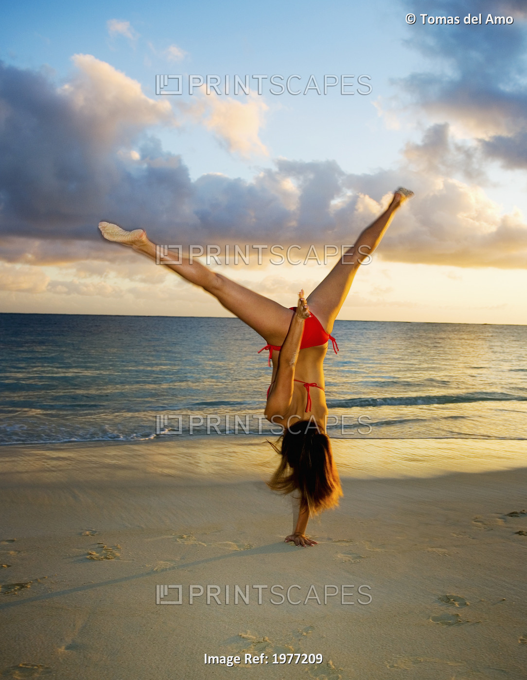 Hawaii, Oahu, Girl On Beach In Swimsuit Doing Gymnastics.