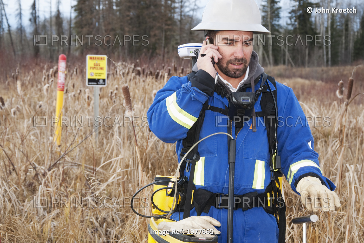 An Inspector Talking On The Phone While Inspecting Pipelines; Whitecourt, ...