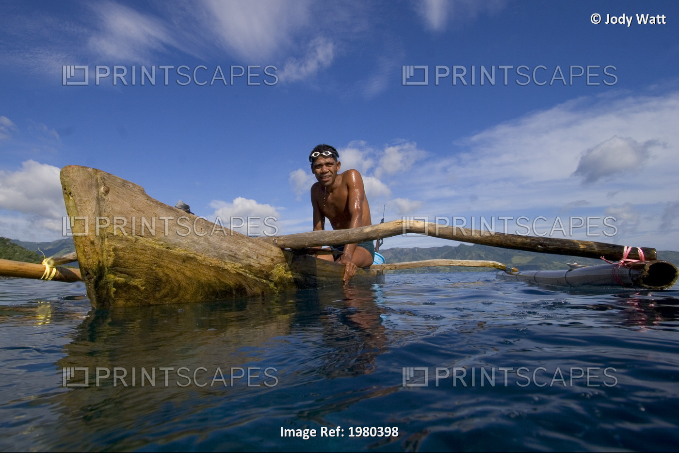 Indonesia, Pura Island, Native Freediver In An Outrigger Canoe.