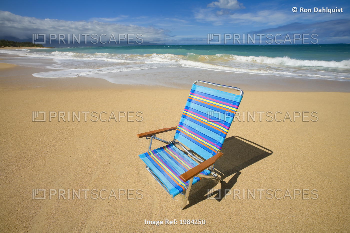 Brightly Colored Beach Chair On The Sand Near The Ocean.