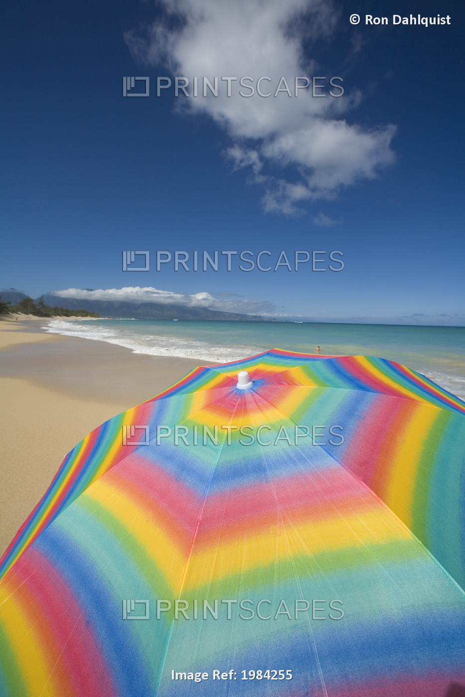 Brightly Colored Beach Umbrella On The Sand Near The Ocean.