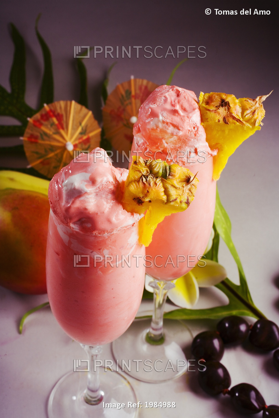 Close-Up Of Two Glasses Filled With A Creamy Pink Tropical Drink.