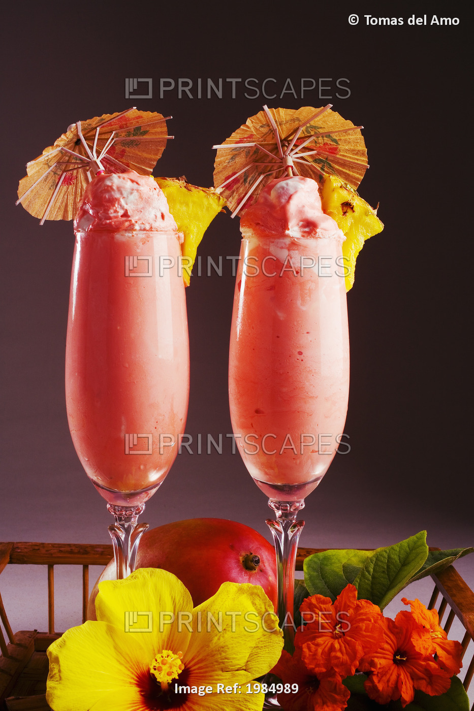 Close-Up Of Two Glasses Filled With A Creamy Pink Tropical Drink.