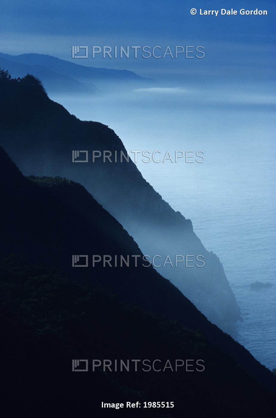 California, Big Sur Coast, Silhouetted Cliffs Along Foggy Ocean Shoreline.