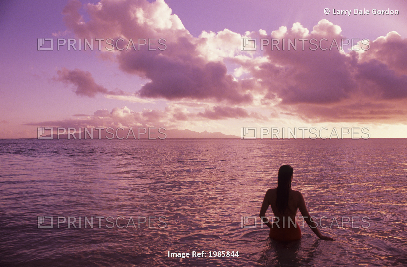 Fiji, Wakaya Island, Woman In Ocean Silhouetted At Sunset.