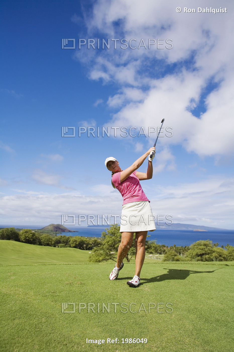 USA, Hawaii Islands, Maui, Female golfer swinging golf club; Wailea Gold Golf ...