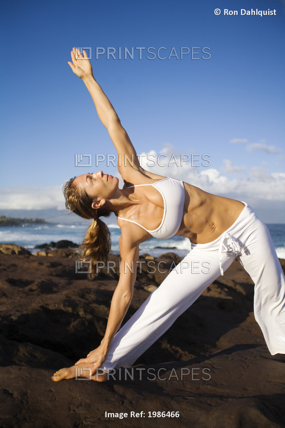 USA, Hawaii Islands, Young woman doing yoga next to ocean; Maui