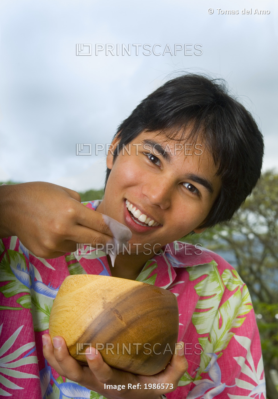 Hawaii, Young Man Eating Poi With Fingers Out Of Wooden Bowl.