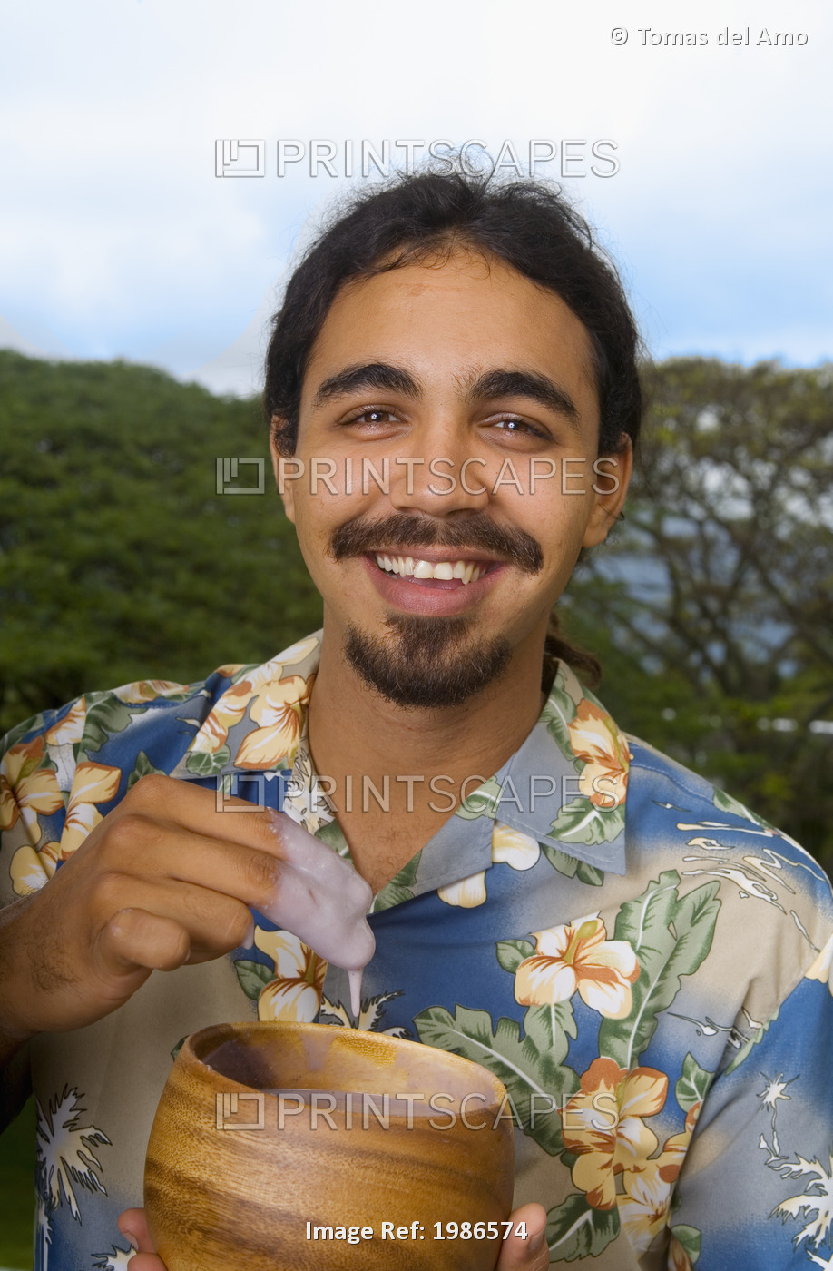 Hawaii, Smiling Local Man Eating Poi With Fingers Out Of Wooden Bowl.