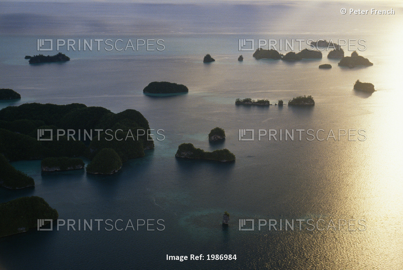 Aerial view of many islands at sunset; Micronesia, Reflections on ocean