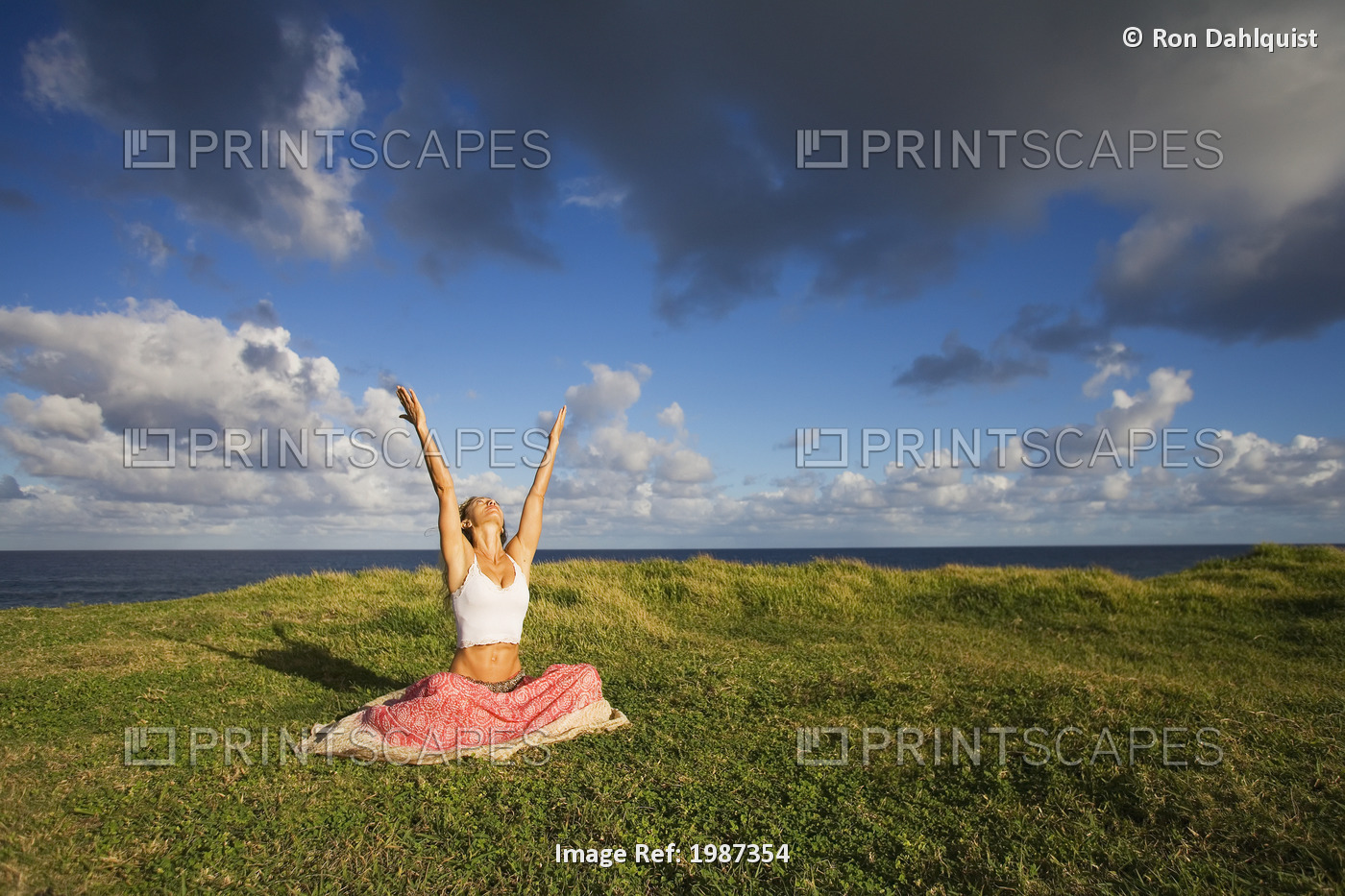 Hawaii, Maui, Young Woman Doing Yoga On Grassy Hill Next To The Ocean.