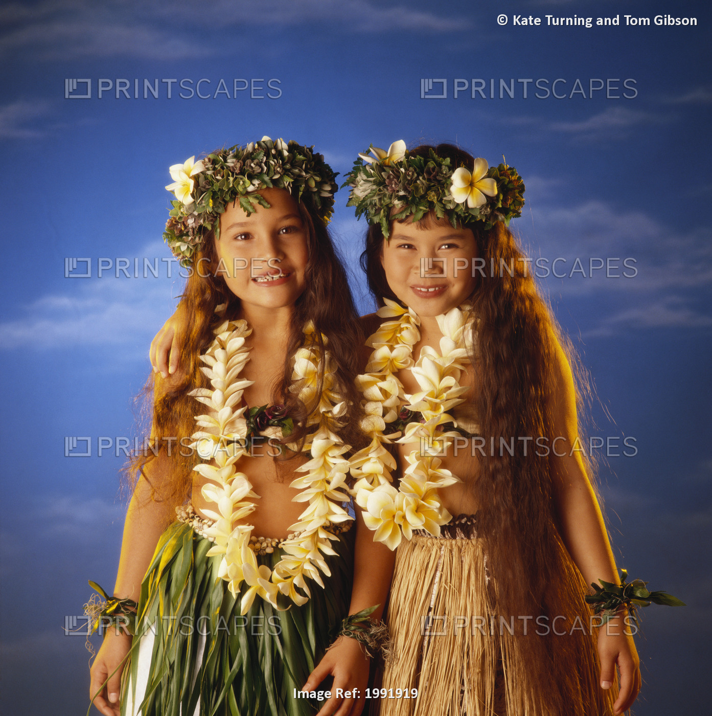 Two Smiling Hula Girls, With Lei And Haku, Standing Together For Studio Shot.