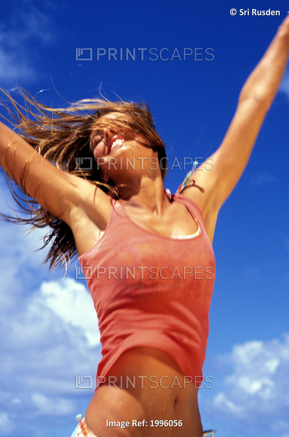 Teen Girl With Arms Spread Up Against Clear Blue Sky, Joy/Freedom.