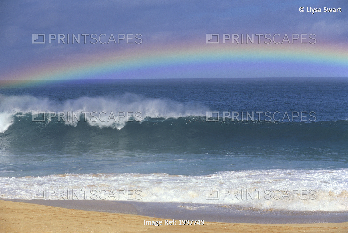Rainbow Over Shore Break Beach Foreground, Horizon And Blue Sky With Clouds A21E