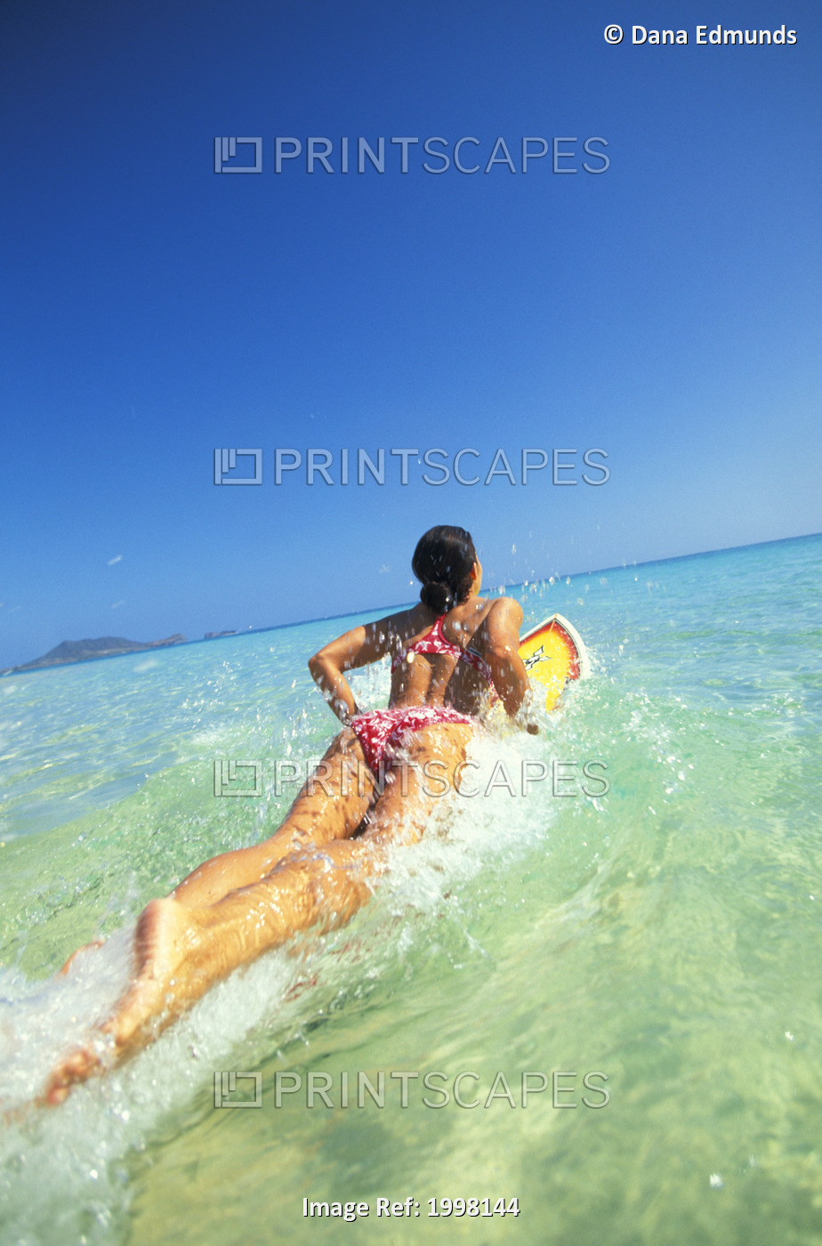 Hawaii, Oahu, Lanikai, Woman Jumping Into Ocean With Surfboard