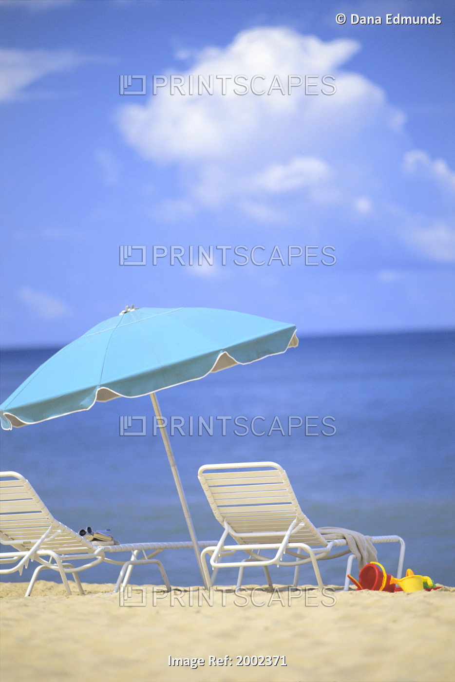 Pair Of Beach Chairs And An Umbrella On White Sand Beach With Blue Skies And ...