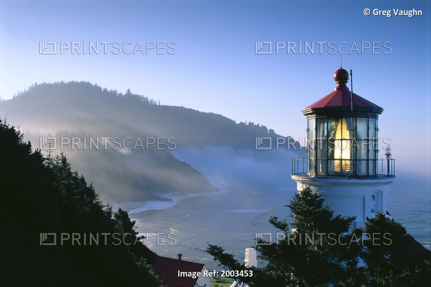 Oregon, View Of Heceta Head Lighthouse Early Morning Sun, Tree Covered Mountains