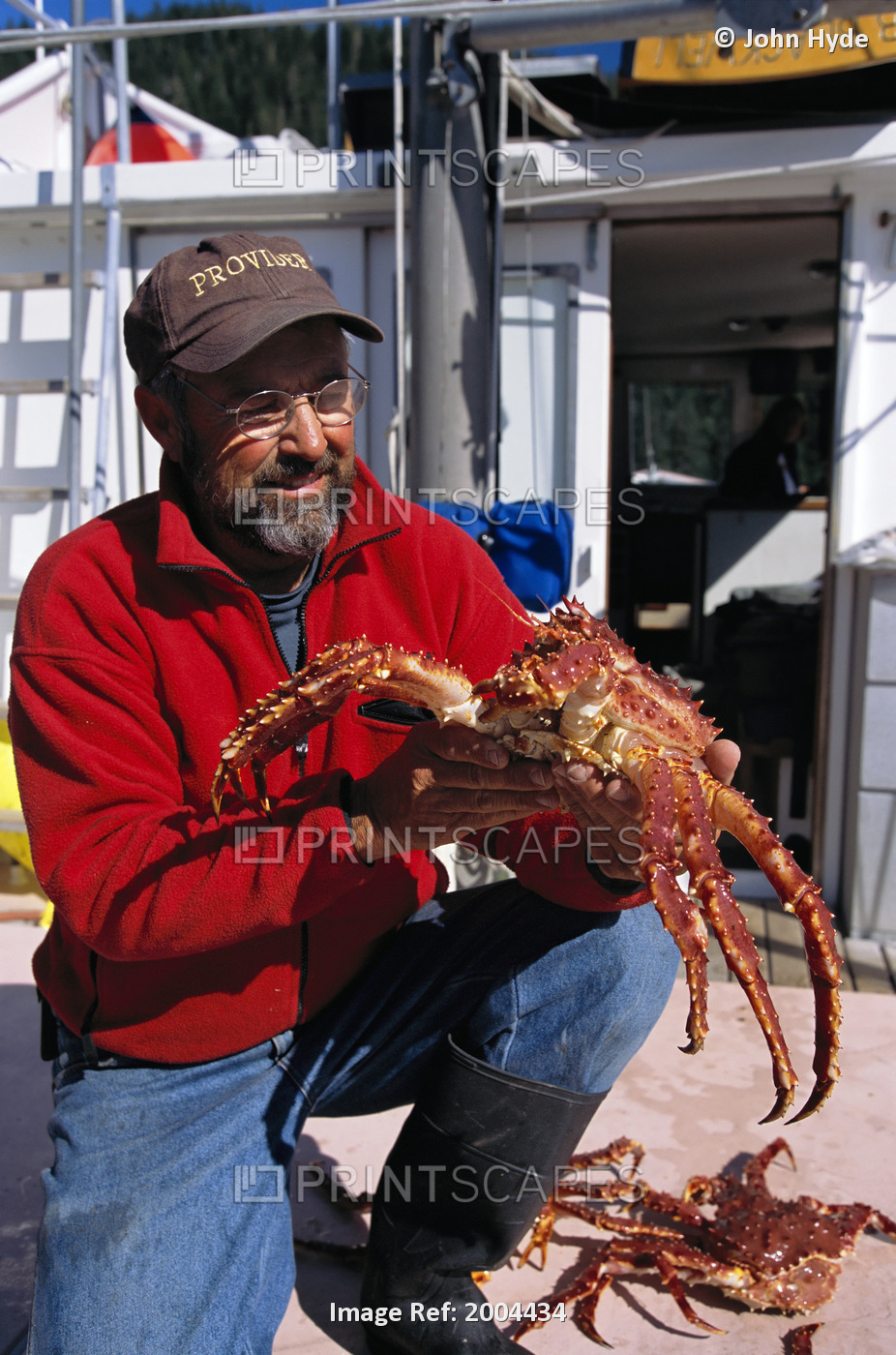 Alaska, Inside Passage, Man Holding And Looking At King Crab