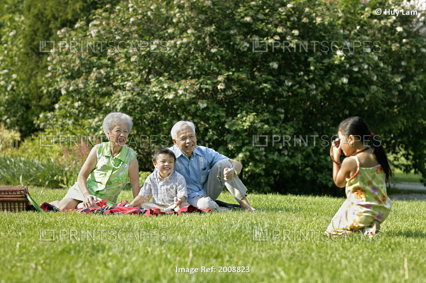 Girl Taking Photo Of Family In Park, Toronto, Ontario