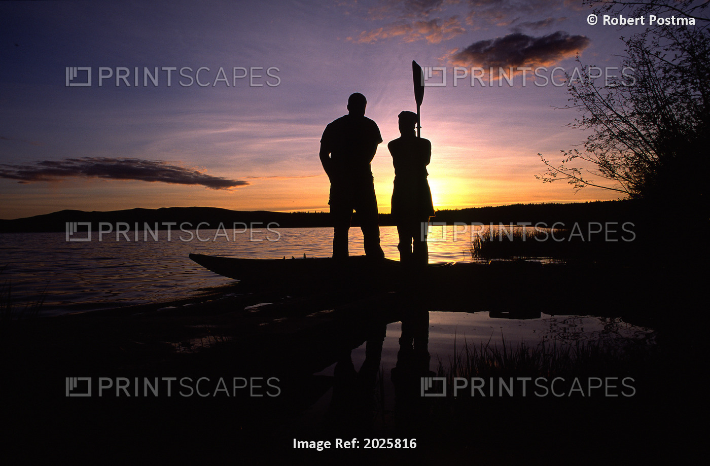 Couple Silhouetted By Sunset Standing Beside A Kayak, Yukon