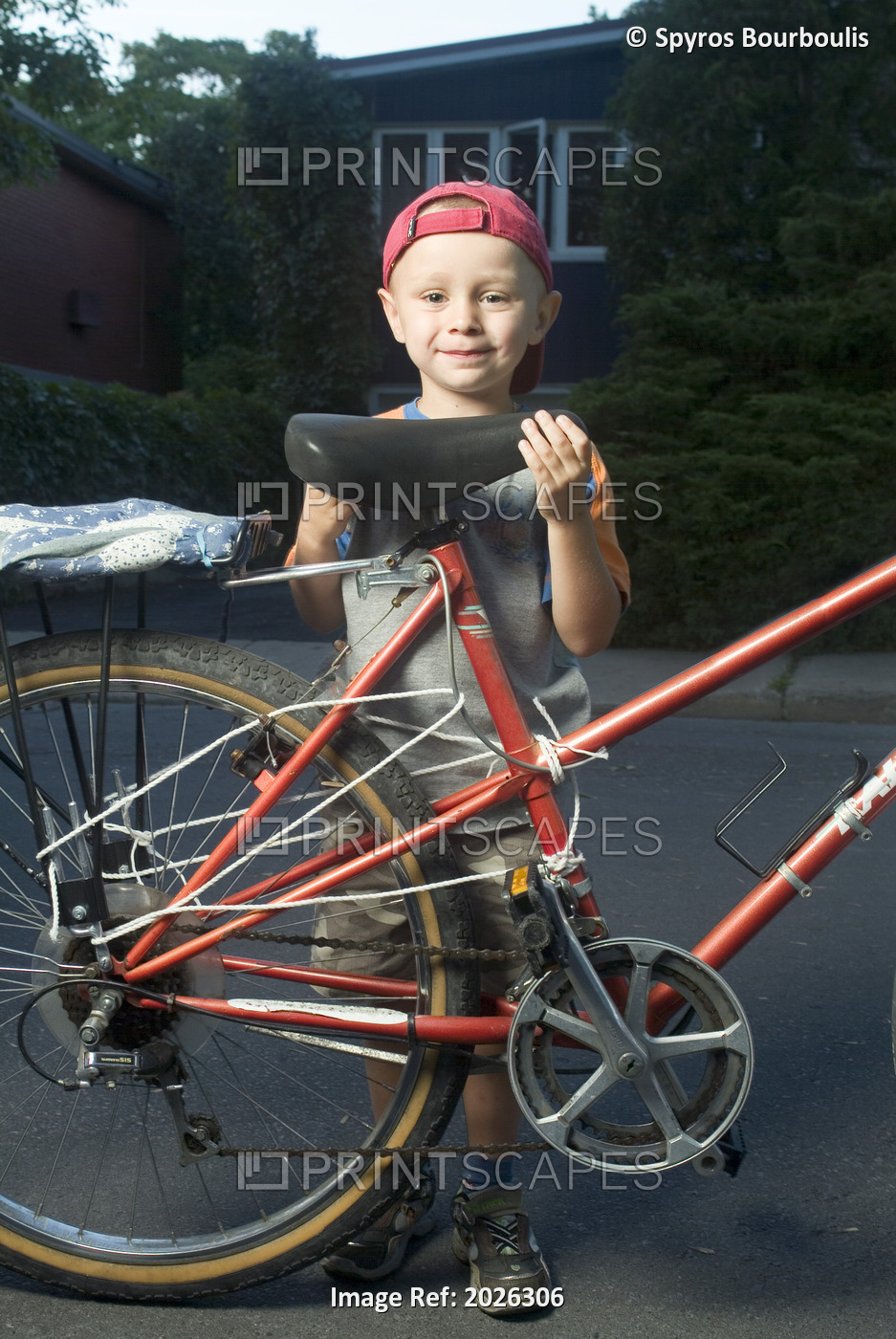 Little Boy Standing Beside An Adult Bicycle, Laval, Quebec