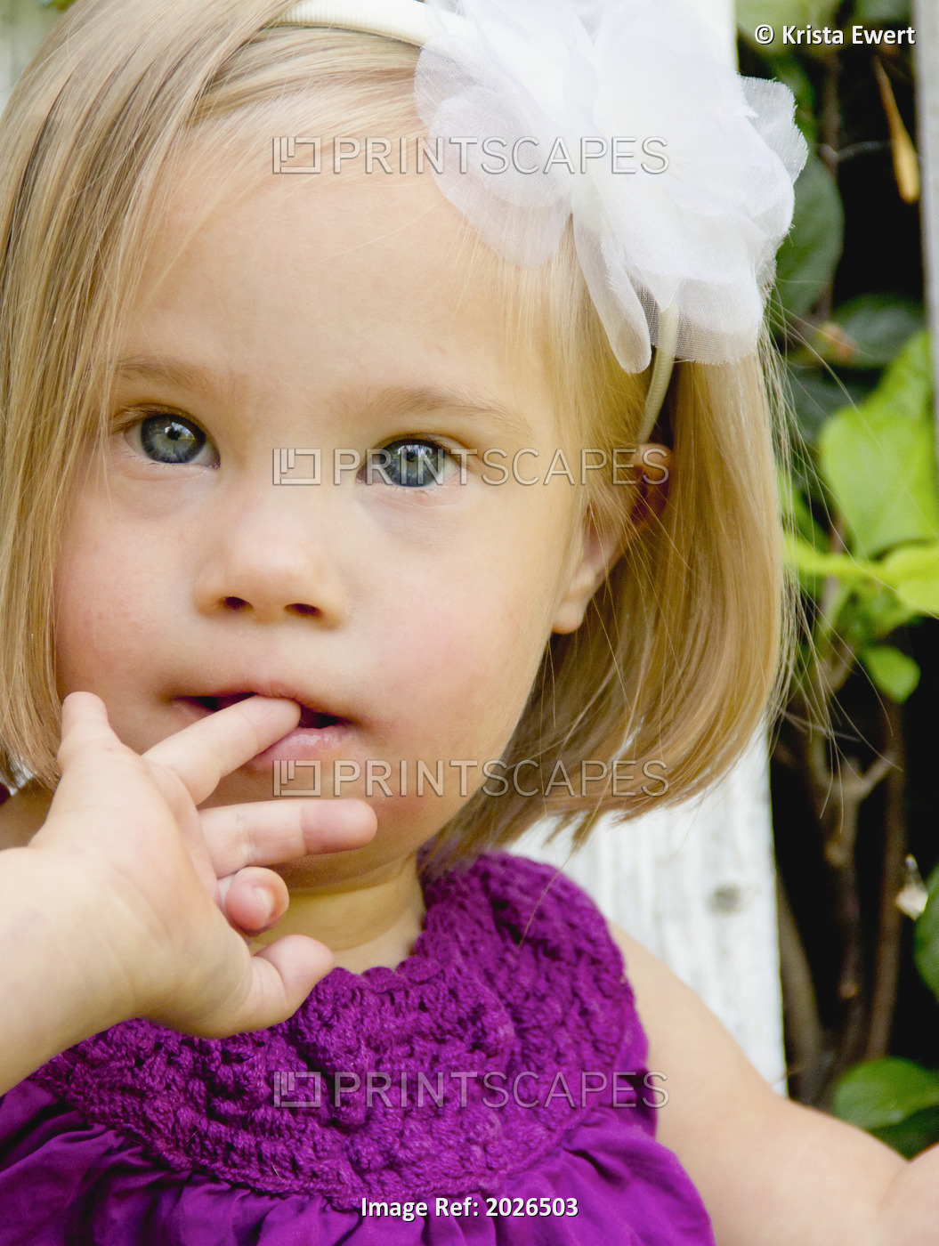 Portrait Of A Young Girl With Down Syndrome With Her Finger In Her Mouth; Three ...