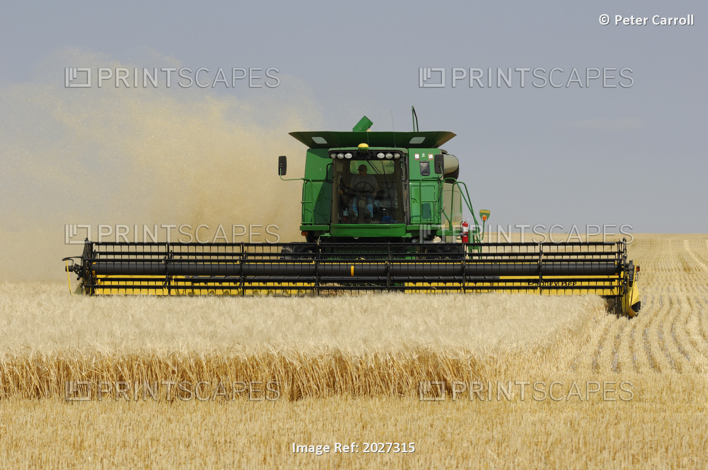 Combine Working A Field On The Prairies, Southern Saskatchewan