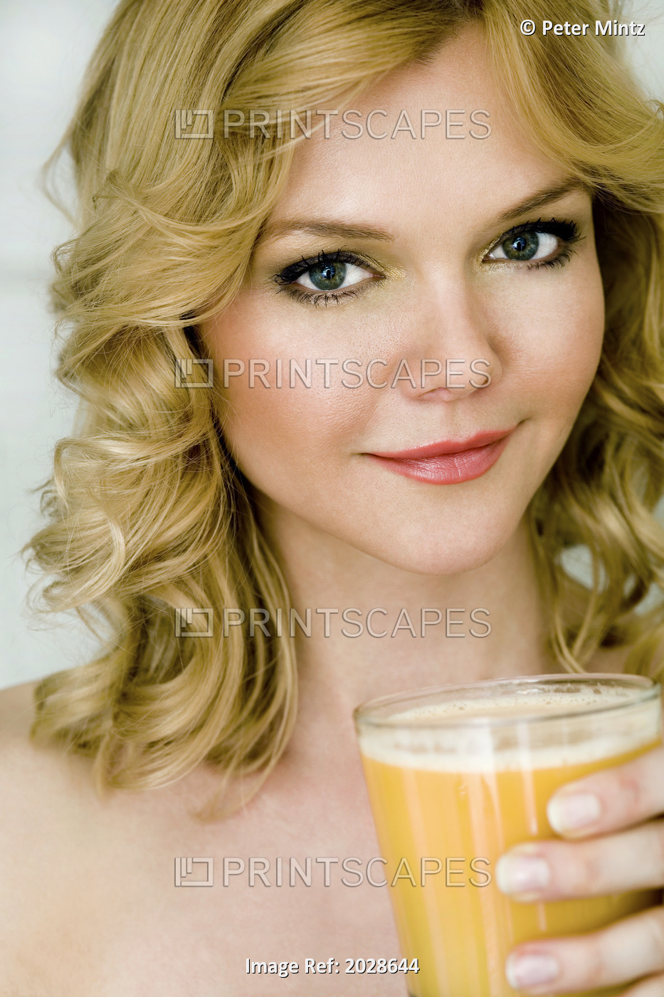 Portrait Of A Woman Holding A Glass Of Orange Juice