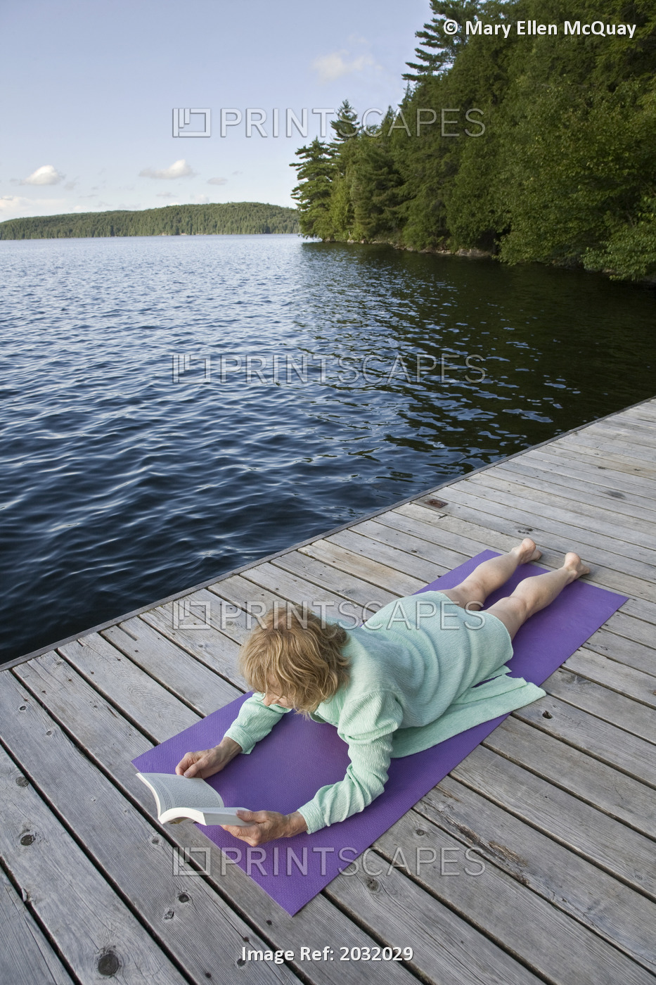 Woman Reading On Cottage Dock, Smoke Lake, Algonquin Park, Ontario