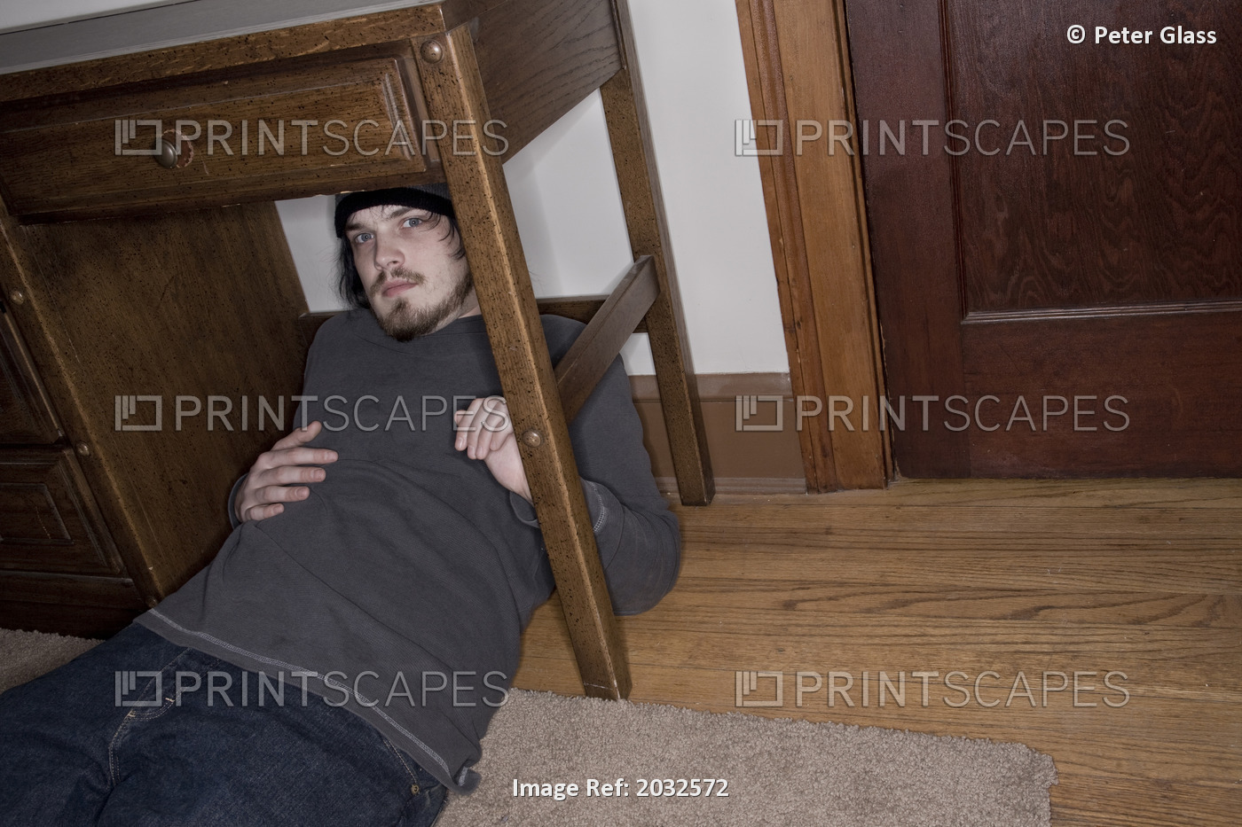 Young Man Sitting Under His Bedroom Desk