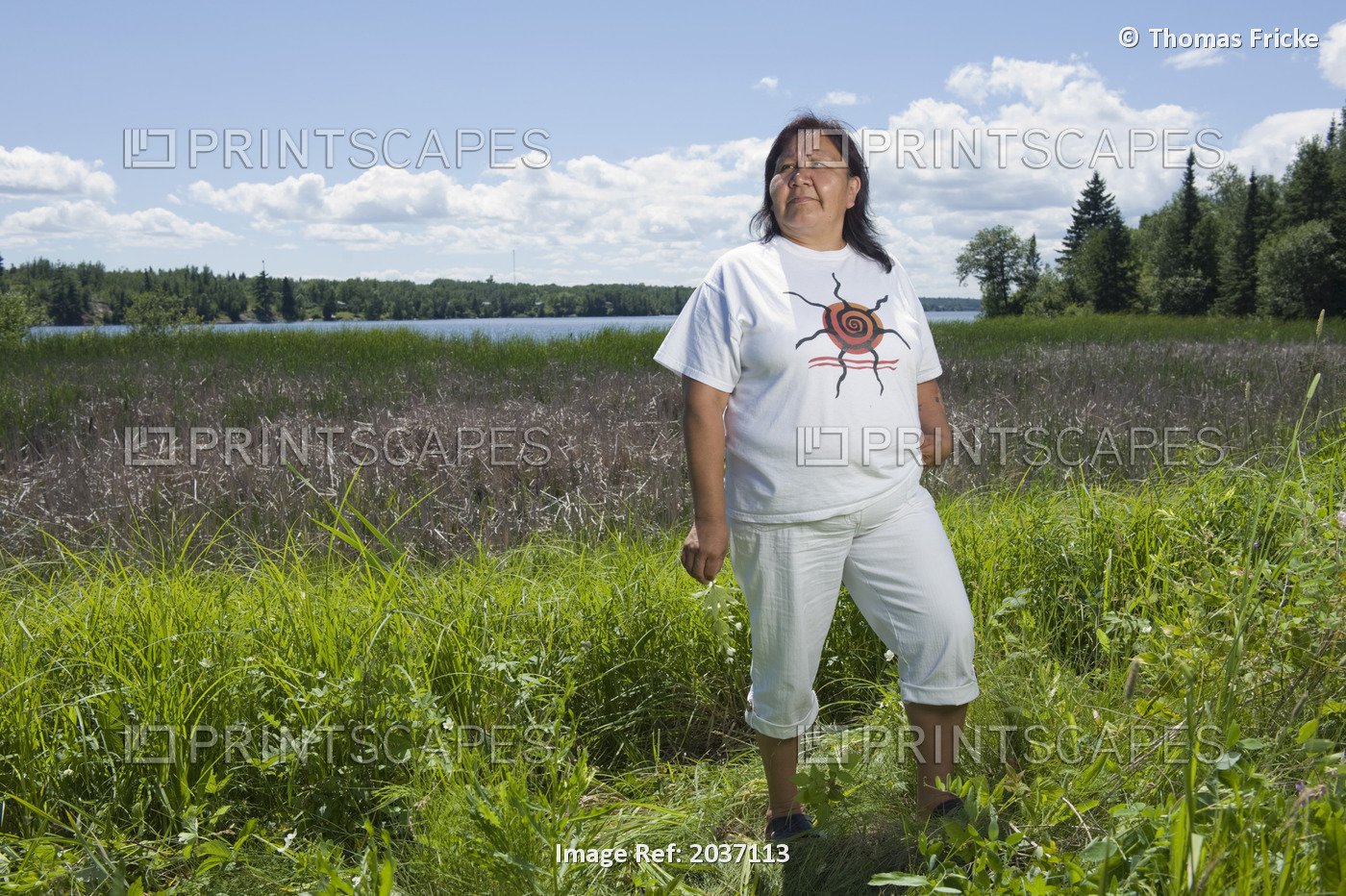 Middle Aged Native American Woman Standing In A Lakeside Field In Shoal Lake, ...
