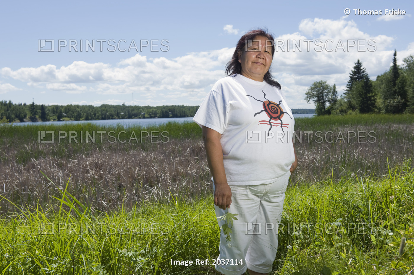 Middle Aged Native American Woman Standing In A Lakeside Field In Shoal Lake, ...