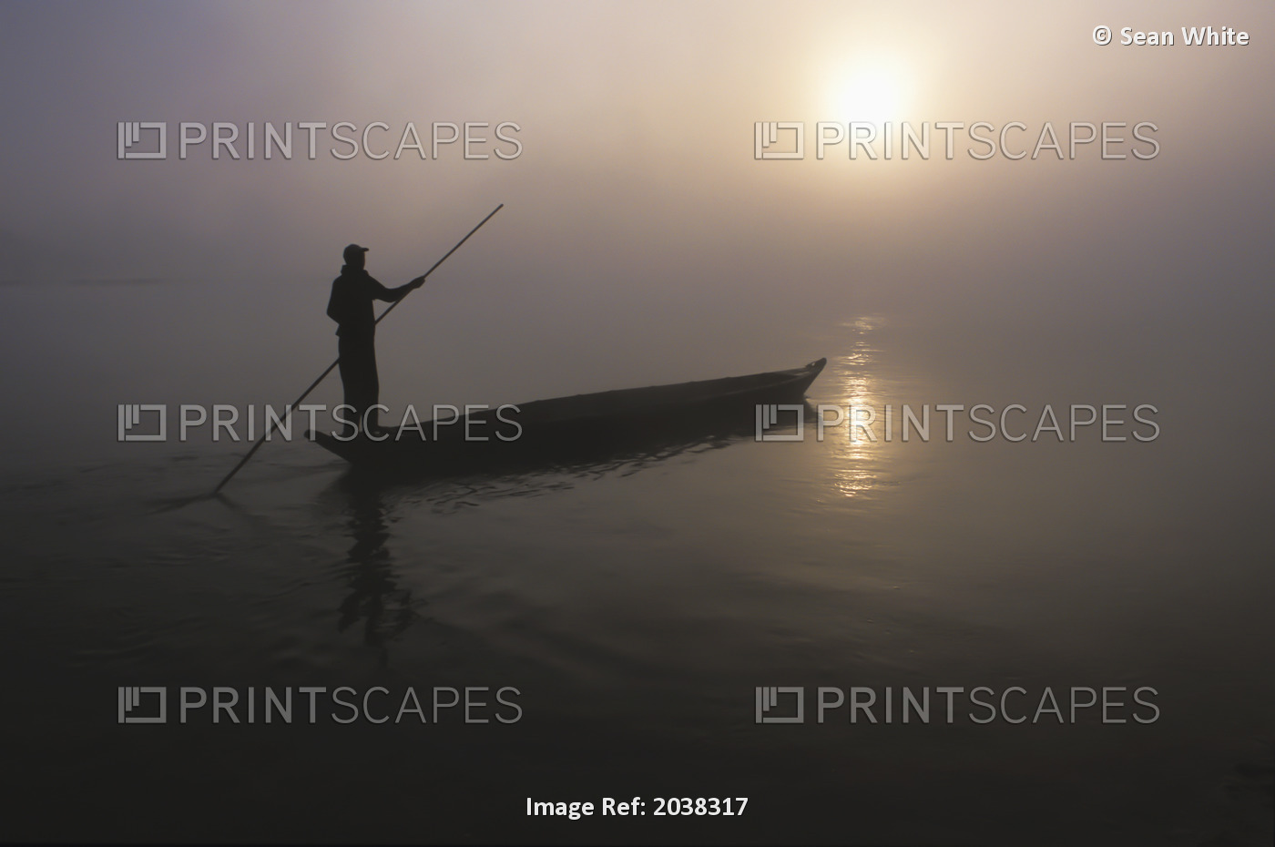 A Man Pushes His Dugout Canoe Along The Rapti River Near Sauraha And Chitwan ...