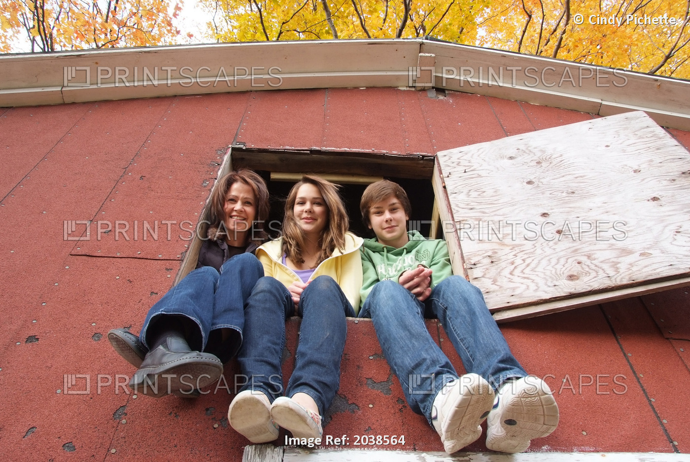 Mom With Two Teenagers Sitting In The Loft Window Of A Barn, Simcoe, Ontario