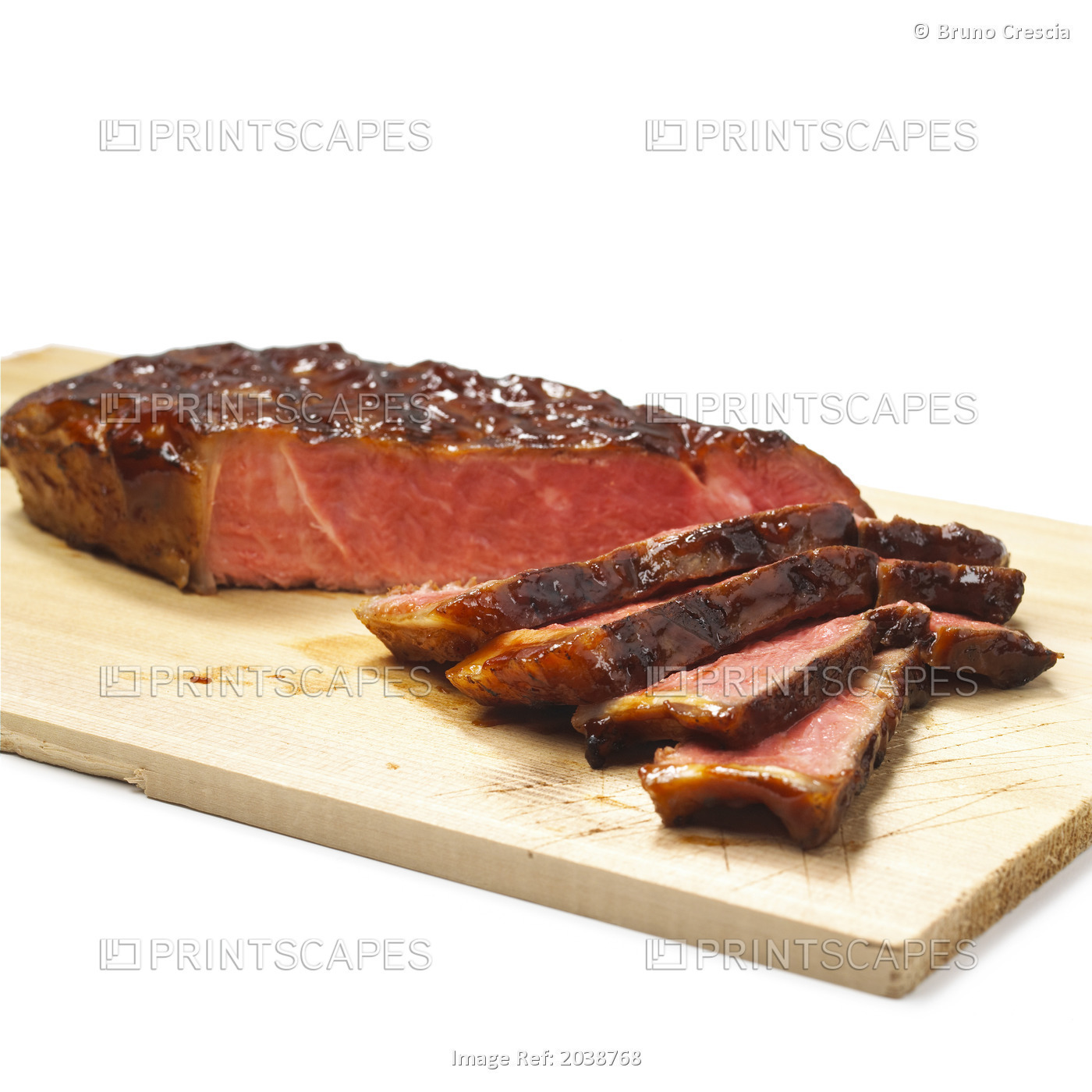 Bbq Steak On A Wood Cutting Board On A White Background