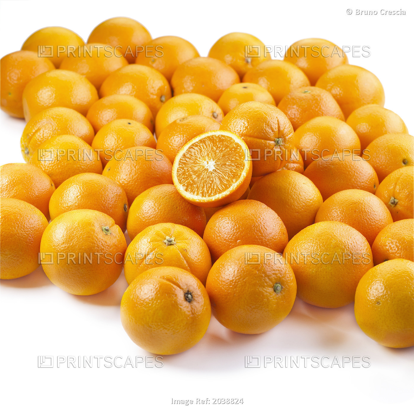 A Slice On A Pile Of Oranges On A White Background