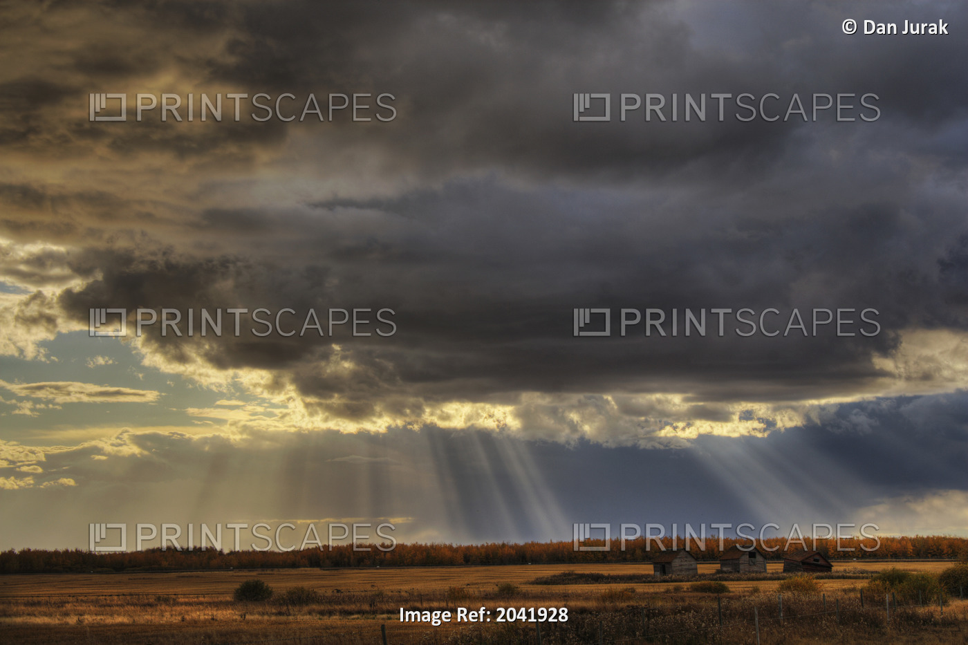 Sun Rays Through Clouds Over Three Old Grain Bins, Rural Alberta