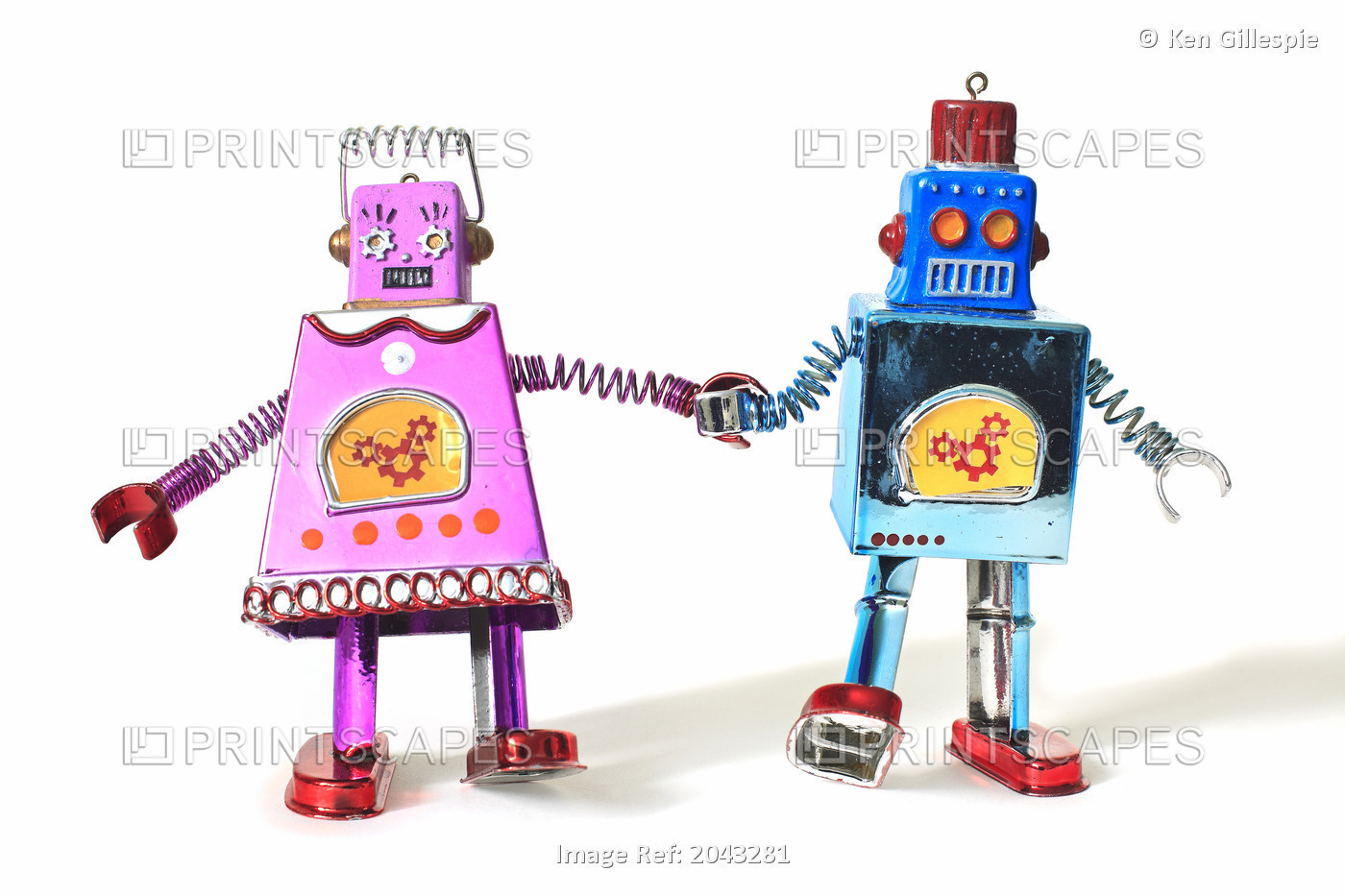 Toy Tin Robots Holding Hands And Walking As A Couple, Male And Female Likeness.
