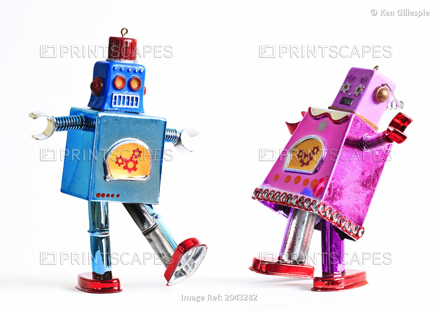 Toy Tin Robots Dancing As A Couple, Male And Female Likeness.