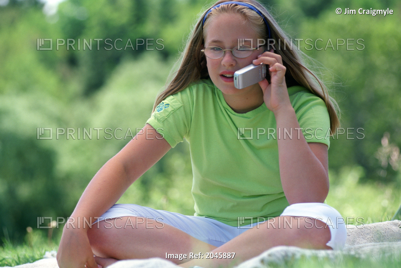 Girl Talking On Cell Phone Outdoors
