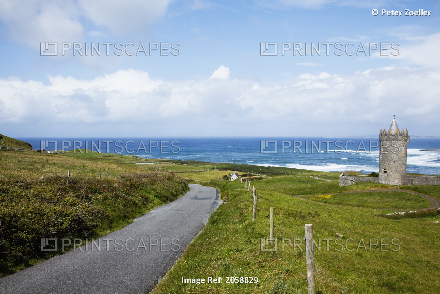 A Paved Road Running Along The Water Near Doolin; County Clare, Ireland