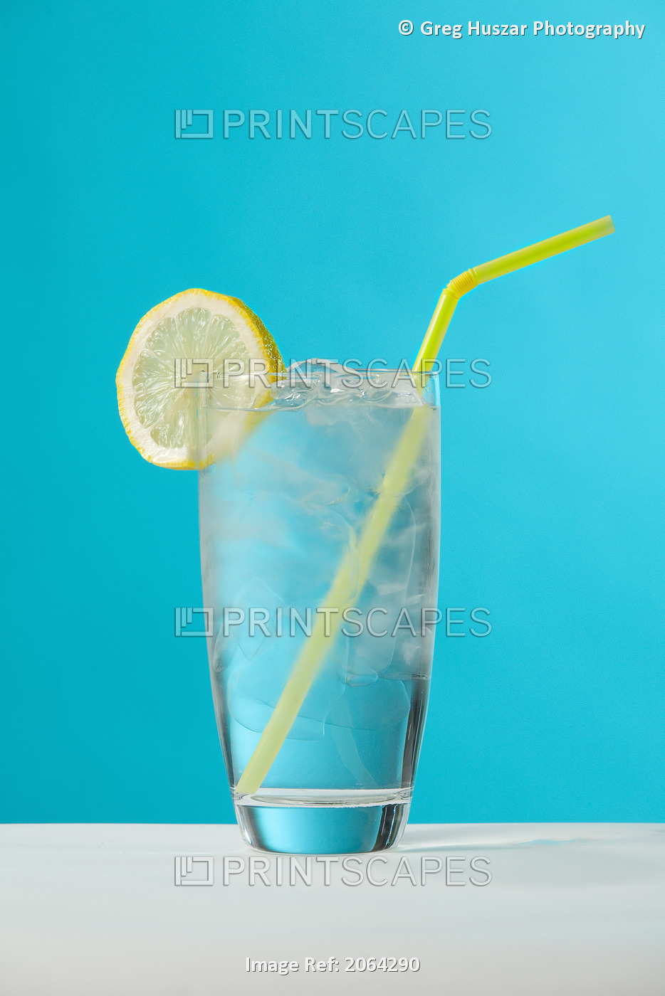 Clear Glass Of Water With Lemon And Drinking Straw