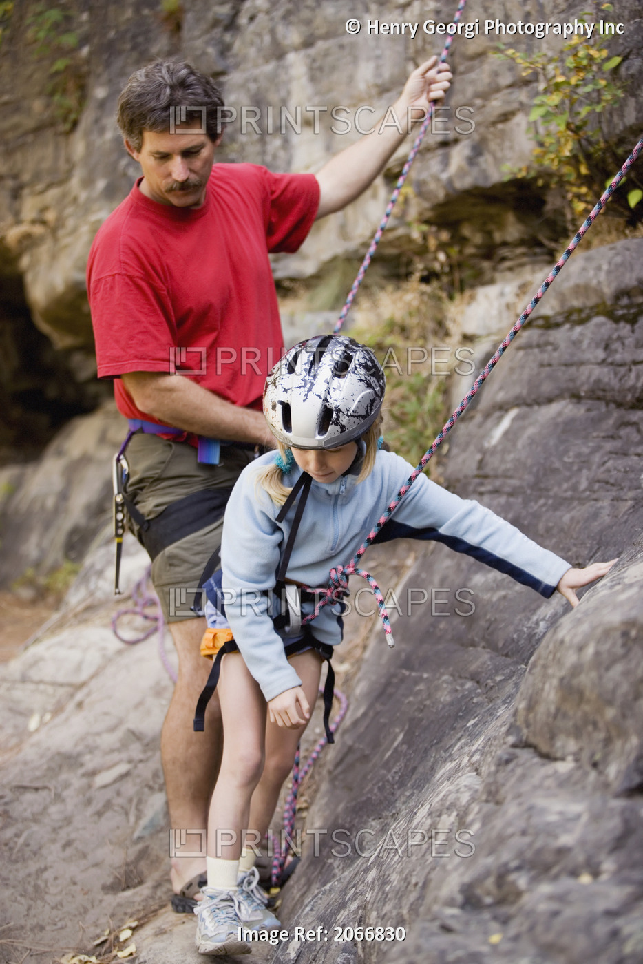 Young Girl (Age 7) Preparing To Climb While Father Belays At Stone Hills Near ...