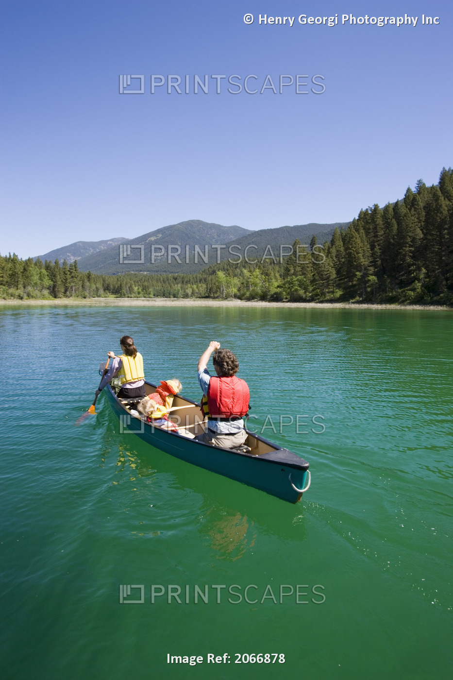 Young Family Canoeing On Loon Lake In The East Kootenays, British Columbia, ...