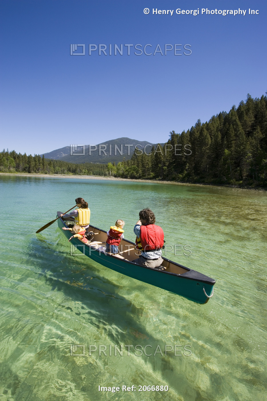 Young Family Canoeing On Loon Lake In The East Kootenays, British Columbia, ...