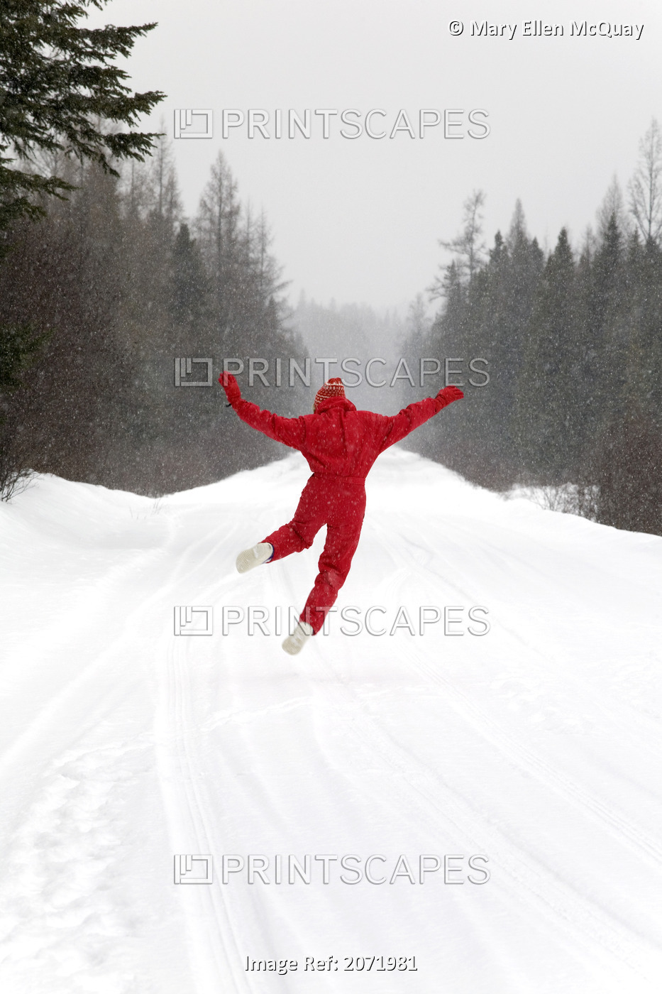 Senior Woman Leaping For Joy In The Snow, Algonquin Park, Ontario